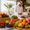 Family in a modern UAE kitchen preparing fresh premium fruits like berries, grapes, kiwi and mangoes.